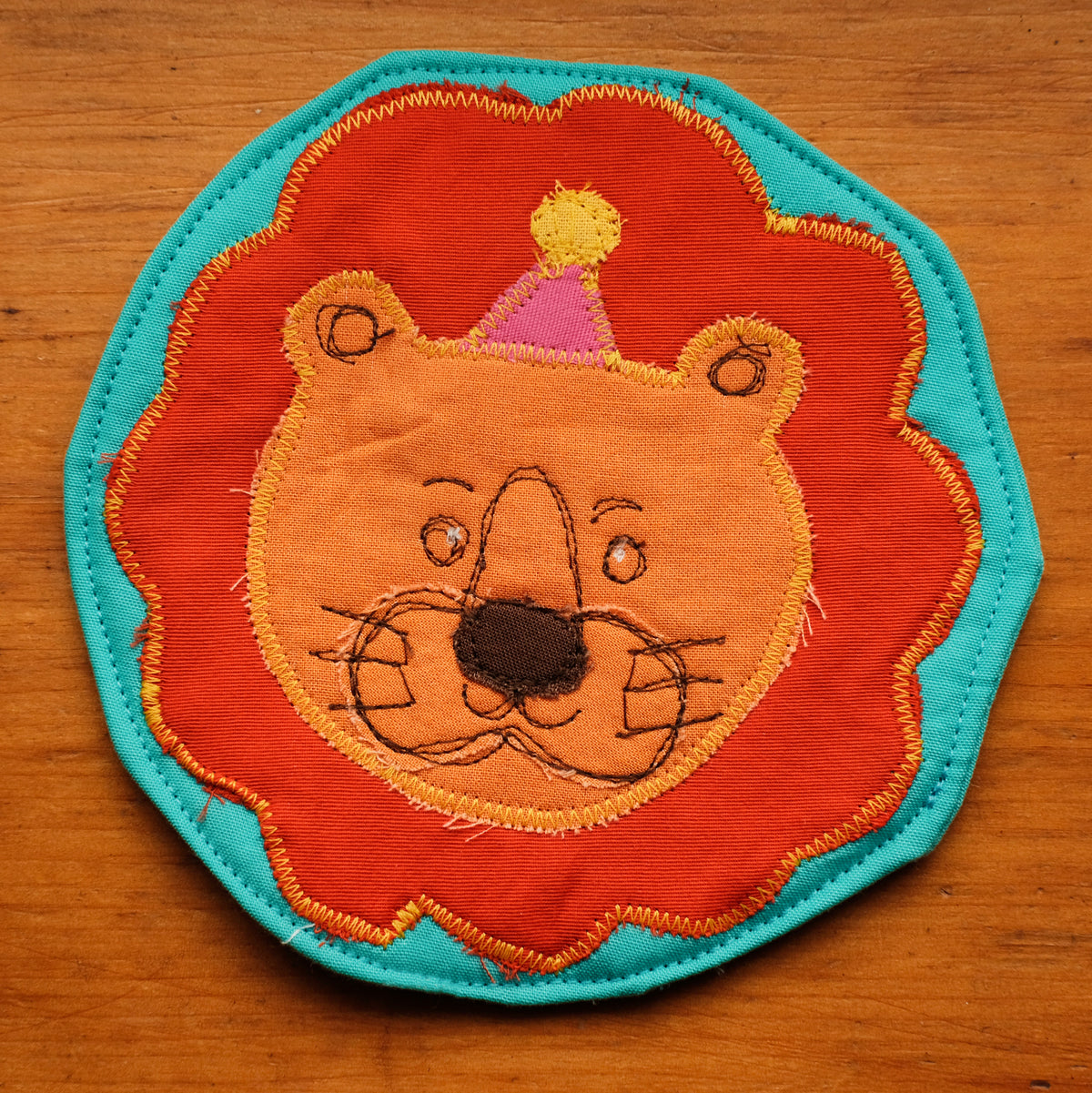 Sous-verre Clownimal Balthazar le lion sur fond bleu turquoise