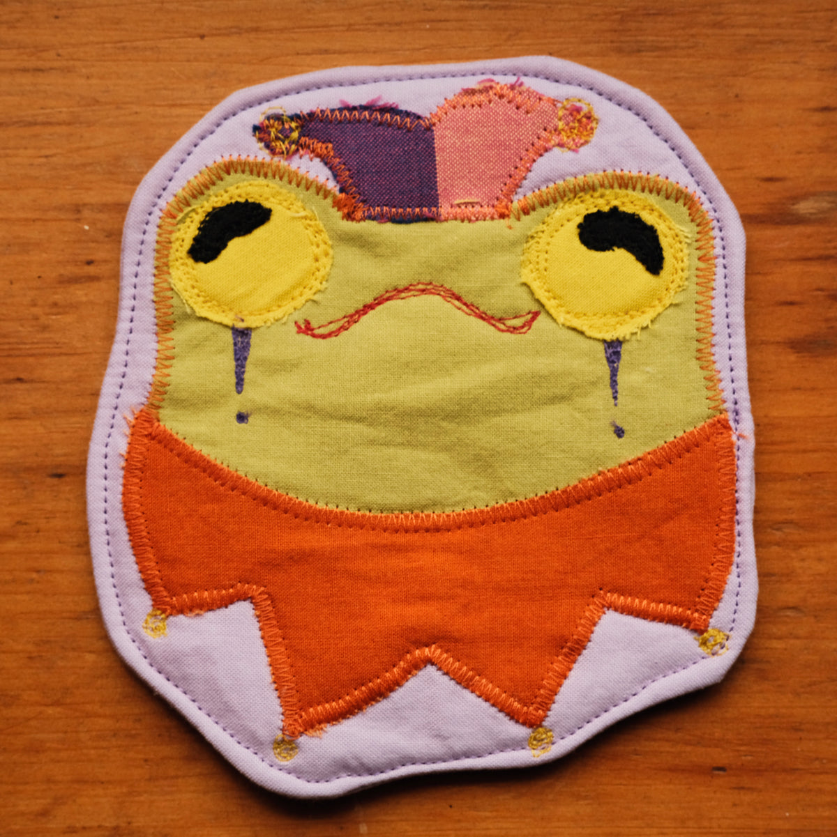Sous-verre Clownimal Lucille la grenouille sur fond lilas